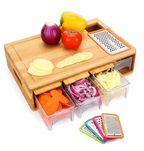 Bamboo cutting board with drawers, grater, and vegetables on a white background