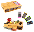 Wooden cutting board set with multiple grating surfaces and a knife on a white background.
